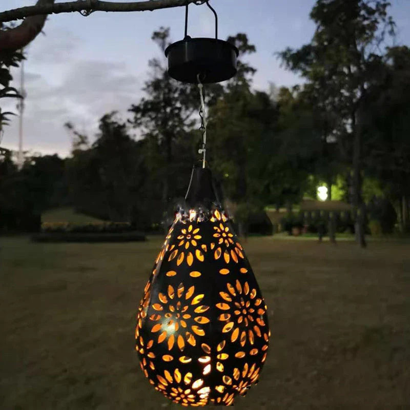 Solar-powered outdoor hanging lantern with flower-patterned shade, made of durable metal for long-lasting use in gardens, patios, and pathways.