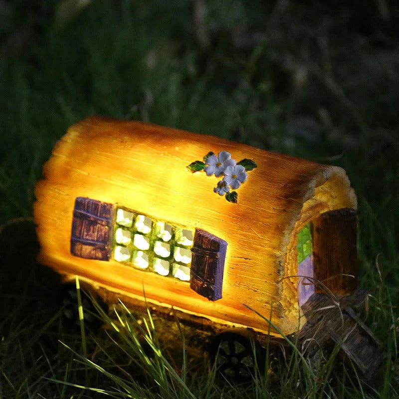 Solar-powered fairy house lamp with warm, inviting glow for outdoor garden decor