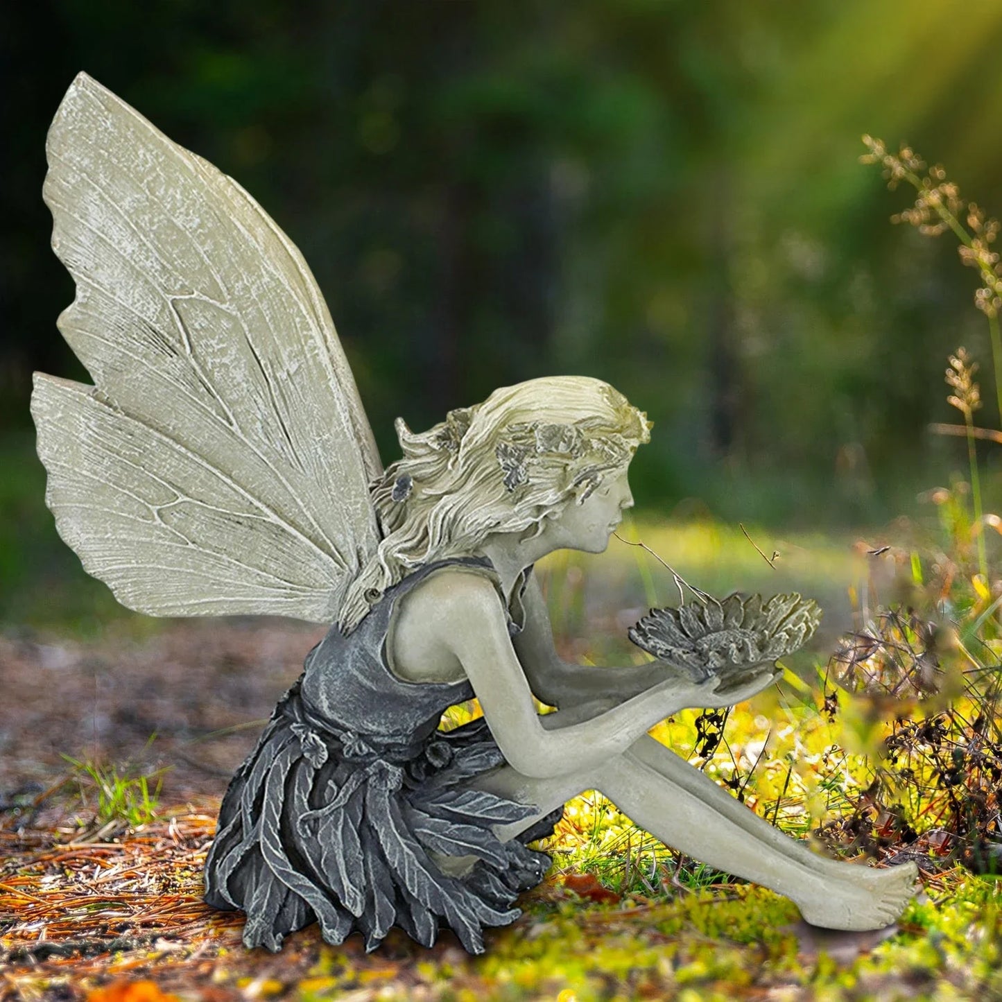 A beautiful resin fairy garden statue with a flower crown and petal skirt, holding a sunflower bowl to attract birds