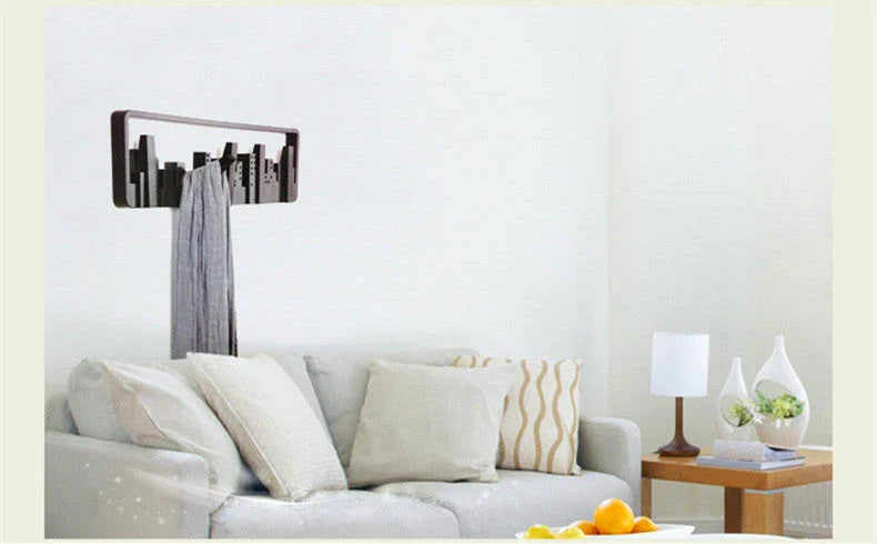 Wall-mounted coat rack with modern, artistic design and 5 flip-down hooks for storing coats, hats, scarves, and more