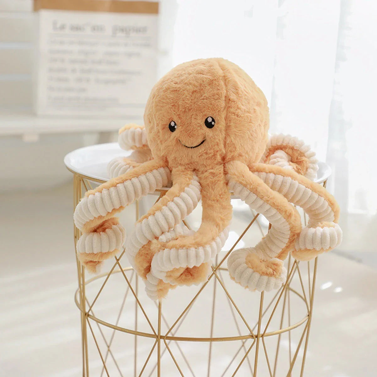 Plush octopus toy with big, bright eyes and a charming, smiling expression