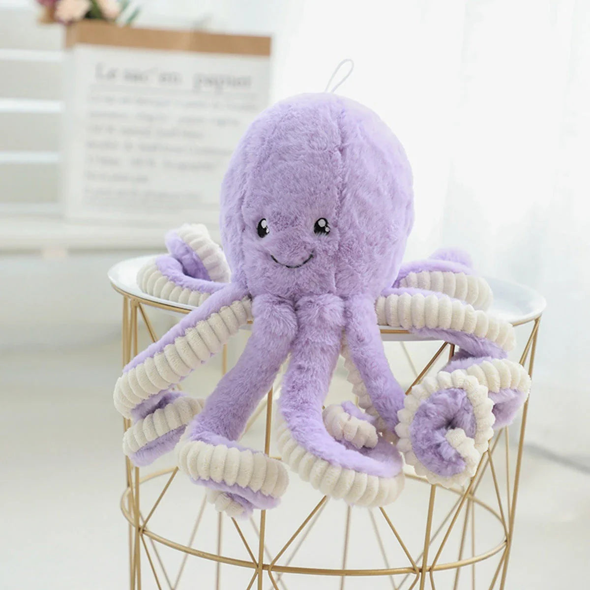 Plush octopus toy with big, bright eyes and a charming, smiling expression