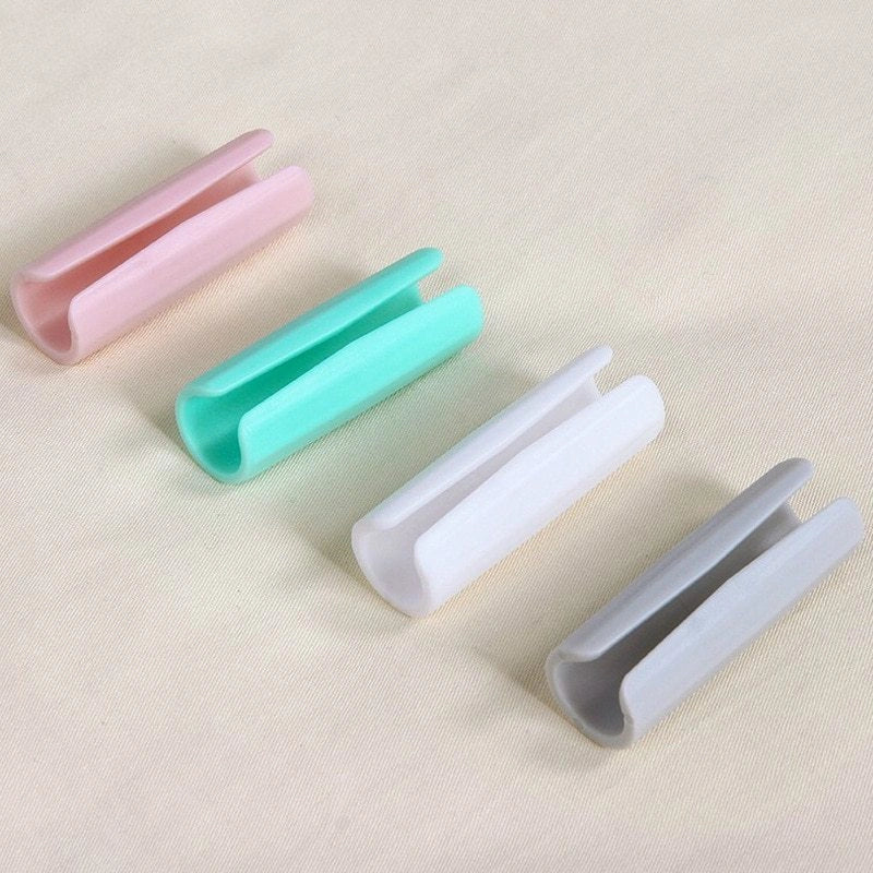 Non-slip sheet fixing clips in various colours for securing bedding and cushions