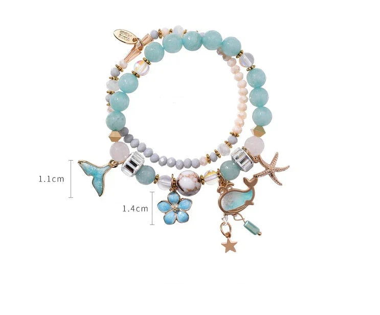 Elegant whale tail bracelet with floral charm in a variety of vibrant colours