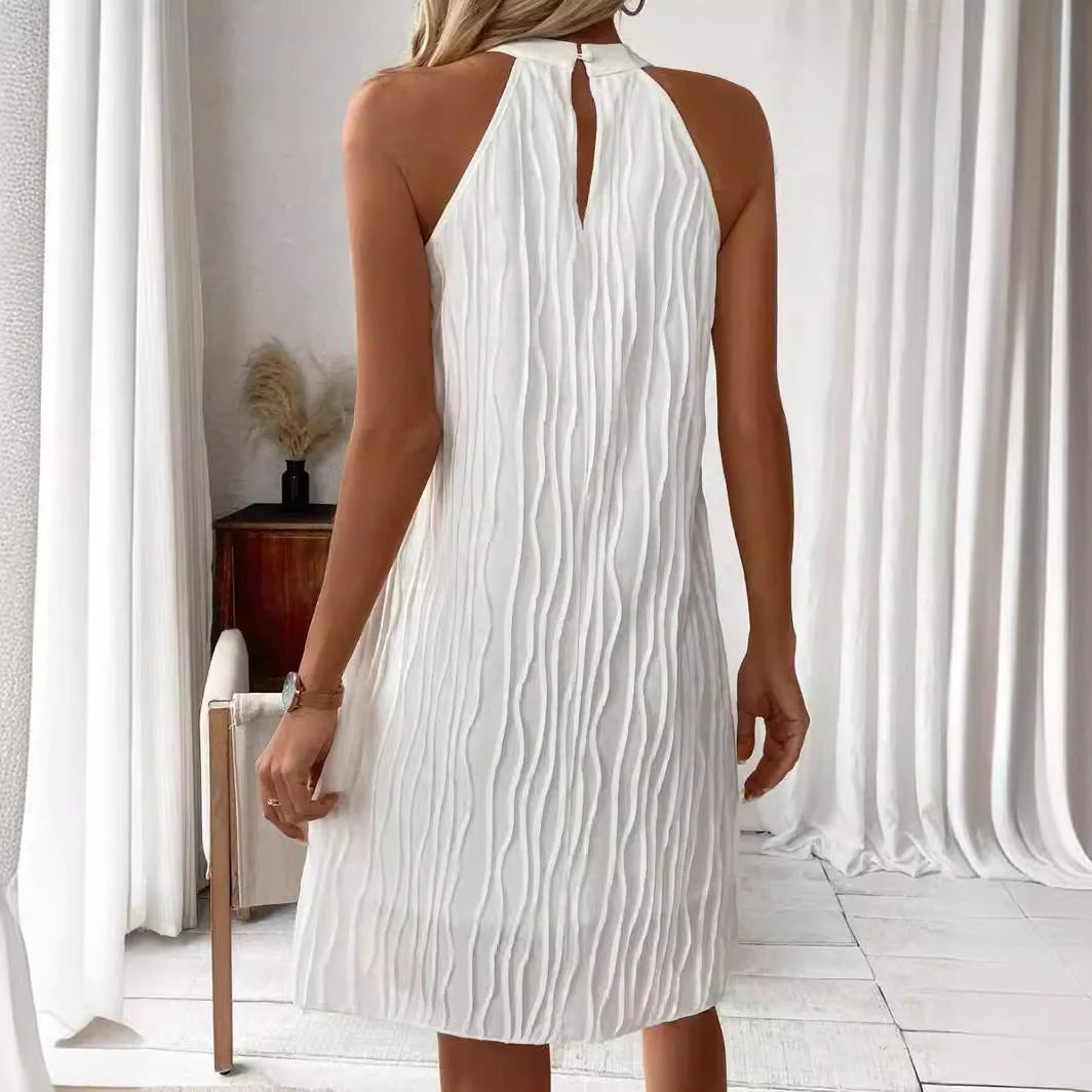 Elegant white backless halter dress with a flattering silhouette and mid-length hemline