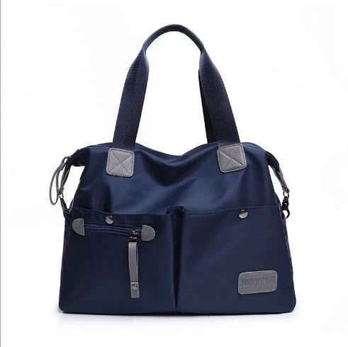 Versatile ladies shoulder bag with multiple carry options, numerous pockets, and durable Oxford fabric construction