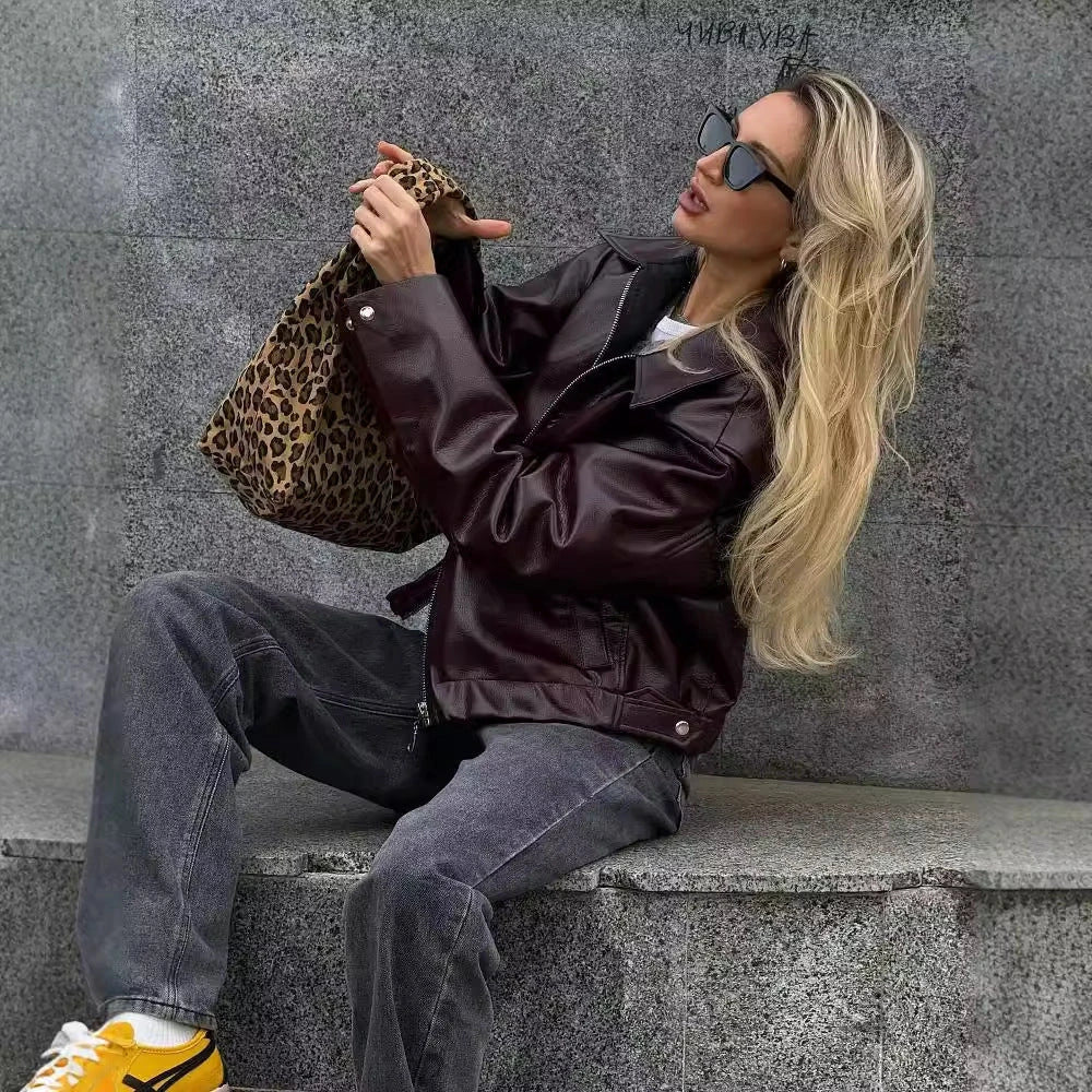 Fashionable faux leather jacket in burgundy and black colors, featuring a zipper closure and long sleeves for casual, versatile wear