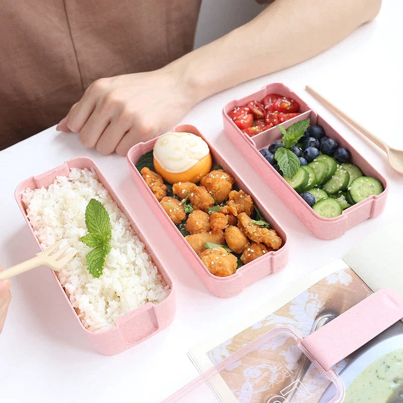 A stylish microwave-safe lunch box with a removable soup mug in various colours, including pink, green, and apricot