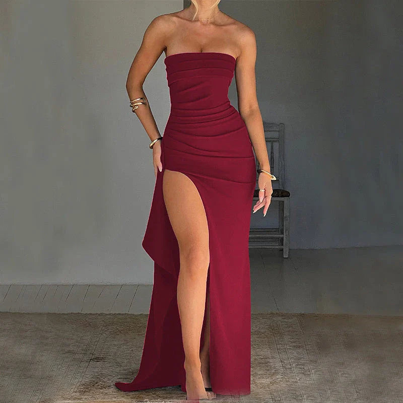 Stunning backless maxi dress in various colors, featuring a pleated A-line skirt and strapless silhouette for elegant occasions.