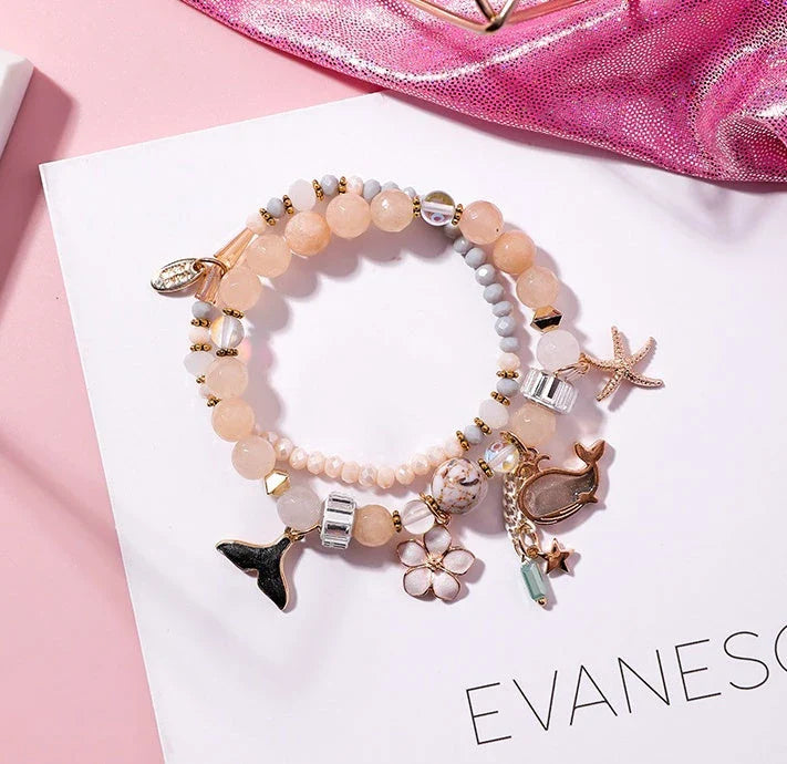 Elegant whale tail bracelet with floral charm in a variety of vibrant colours