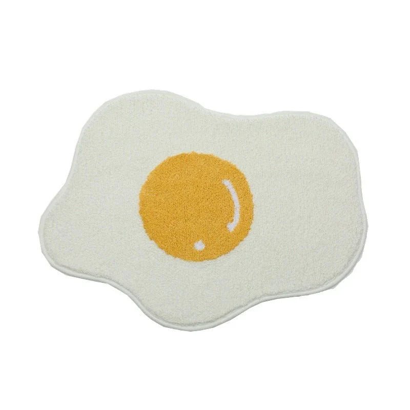 Quirky egg-shaped entrance mat made of absorbent polyester fabric with non-slip rubber backing, available in various sizes and colours