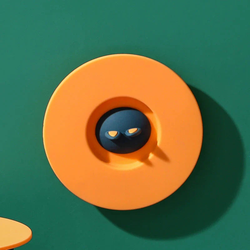 Spill-Proof Cat Ear Silicone Drink Lid in various colors, including pink, orange, and blue