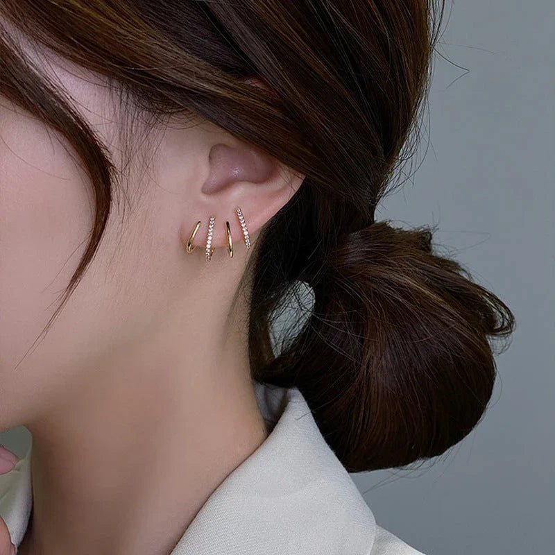 Radiant sterling silver earrings with four-prong zircon stone settings, elegant and fashionable jewelry for women