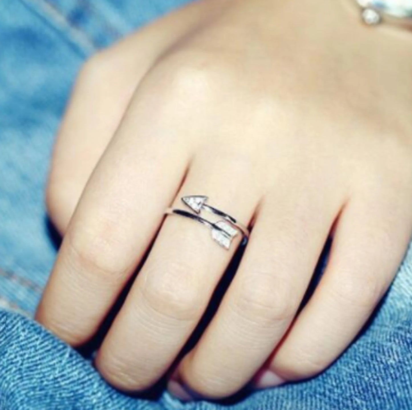 Copper arrow-shaped ring with a sleek, polished finish and a touch of subtle shimmer for a sophisticated, modern look.