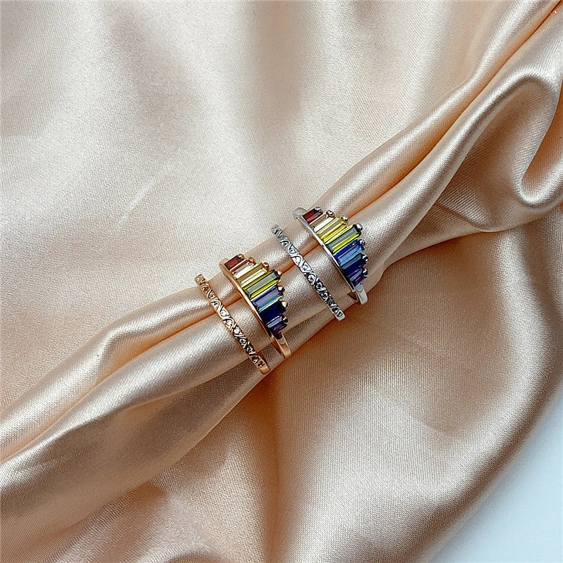 Stylish rainbow micro-diamond ring with a geometric design, available in silver and rose gold finishes