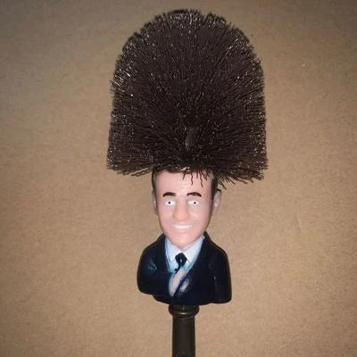 Hilarious Trump-themed toilet brush with bright yellow color and distinctive design