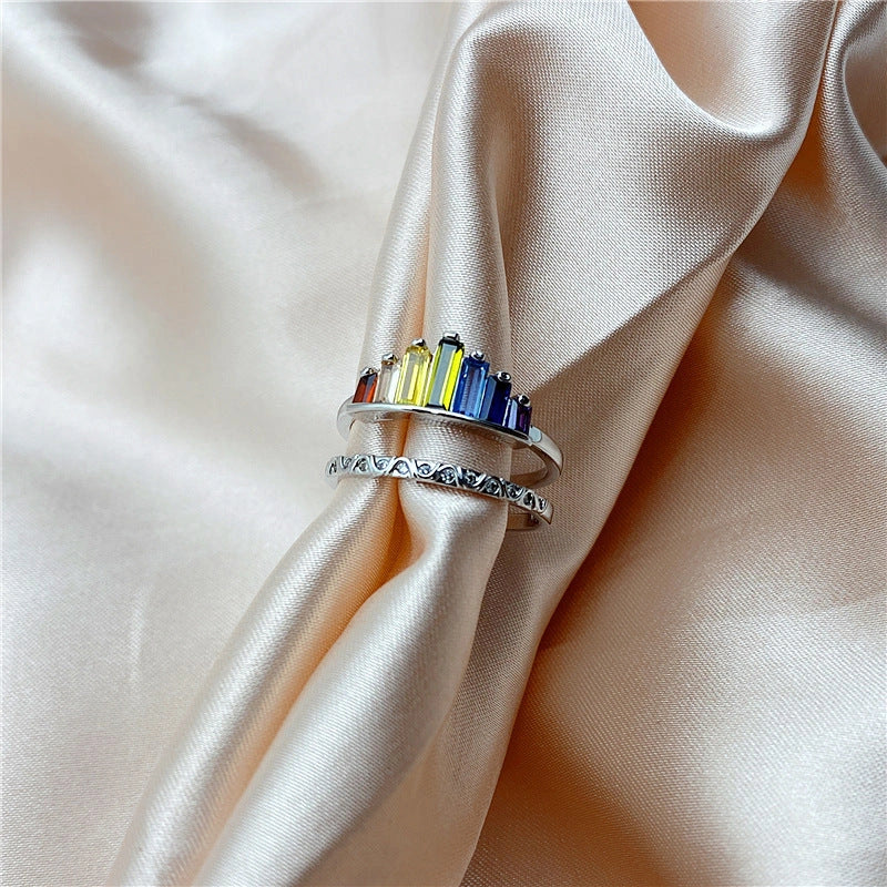 Stylish rainbow micro-diamond ring with a geometric design, available in silver and rose gold finishes