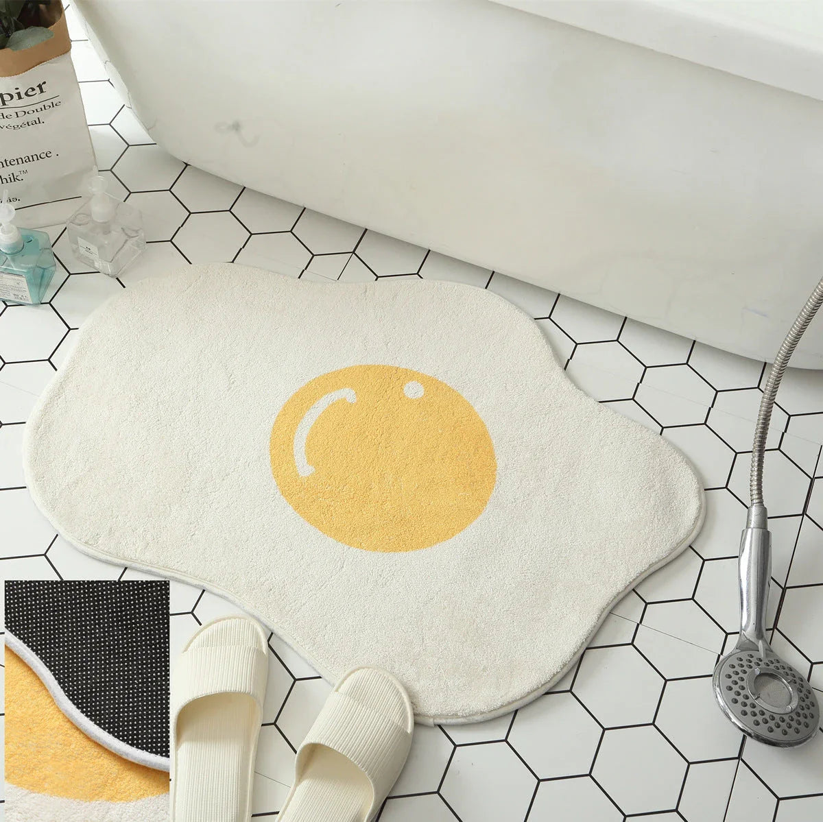 Quirky egg-shaped entrance mat made of absorbent polyester fabric with non-slip rubber backing, available in various sizes and colours