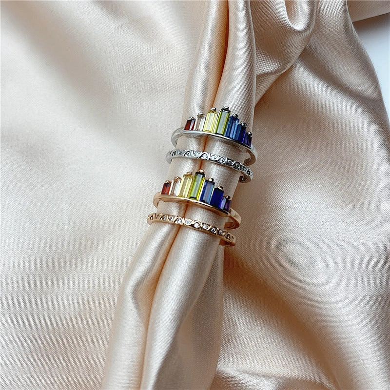 Stylish rainbow micro-diamond ring with a geometric design, available in silver and rose gold finishes