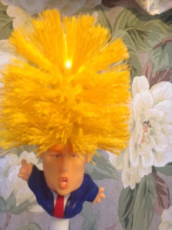 Hilarious Trump-themed toilet brush with bright yellow color and distinctive design