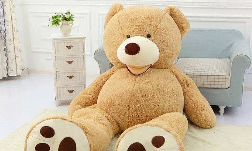 Colossal plush teddy bear in various sizes and colors, including light brown, dark brown, gray, white, pink, and purple