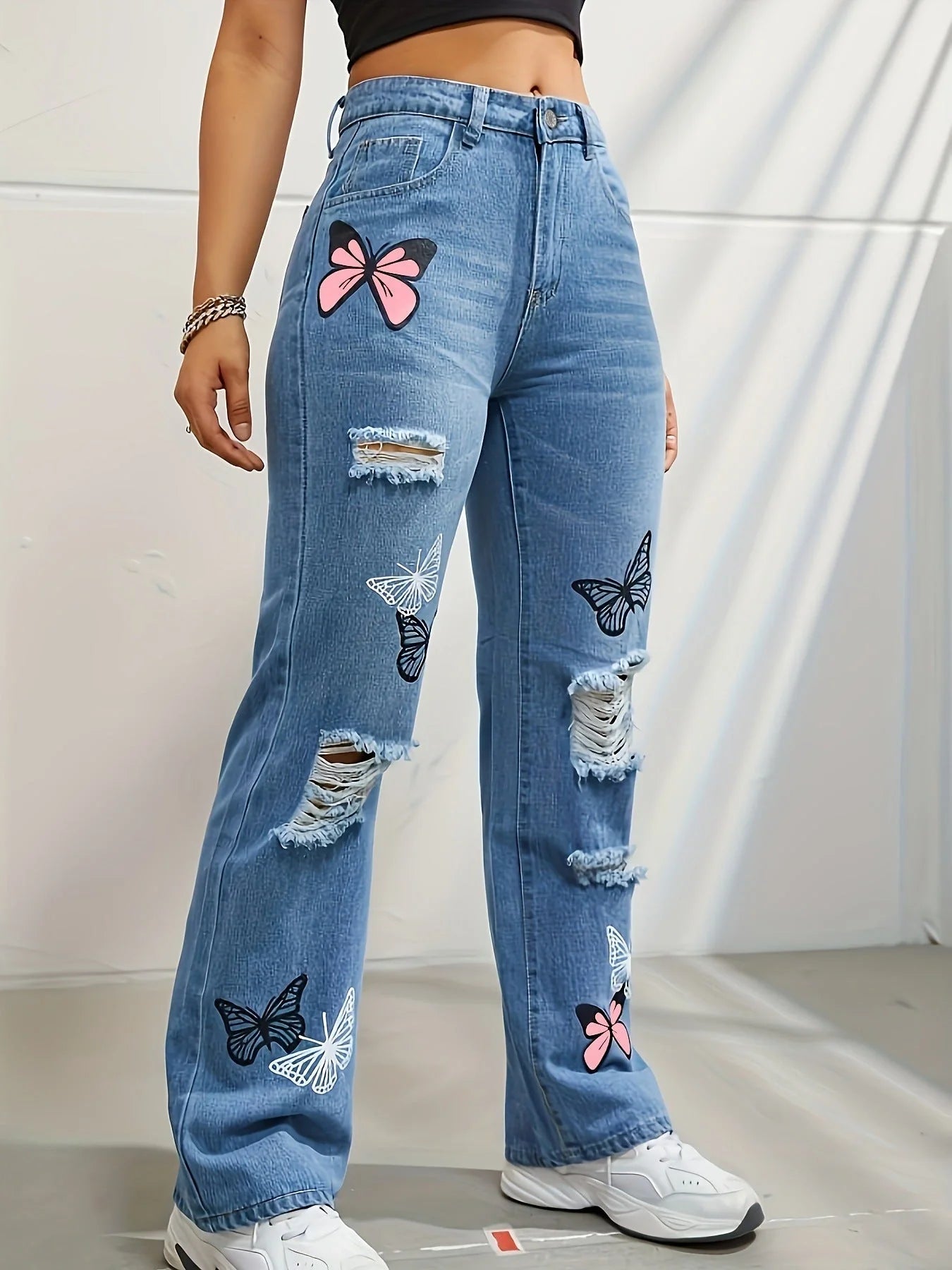 High-waisted straight leg jeans with trendy butterfly print, distressed detailing, and button closure for a stylish, flattering look.