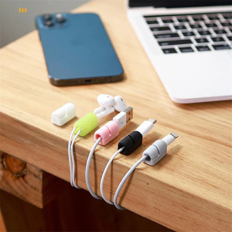 Premium silicone cable clips in various colours for organising and managing cables on desks, entertainment units, and other surfaces