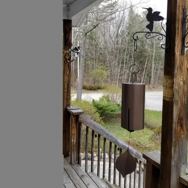 Handcrafted metal wind chimes in black and brown colors, available in small and large sizes, creating a serene outdoor ambiance