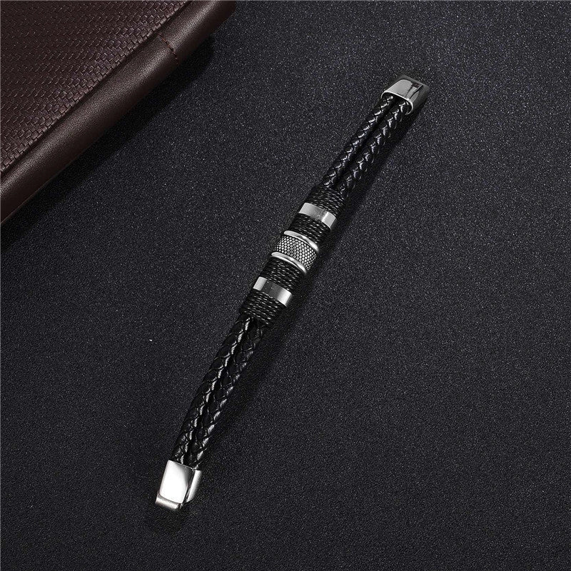 Premium black braided leather bracelet with titanium and stainless steel clasp, a timeless accessory for the modern gentleman