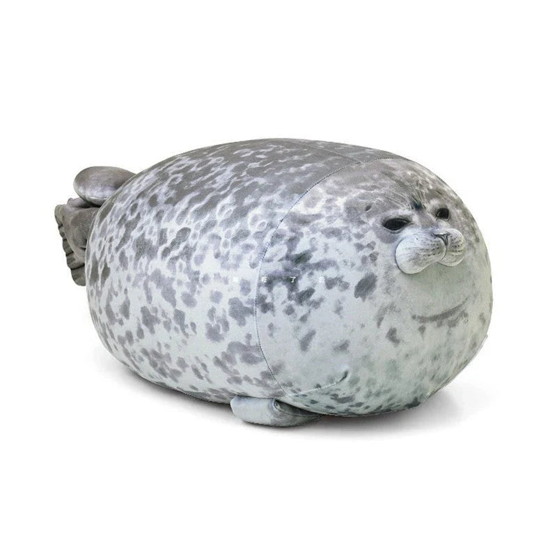 A plush, soft, and cuddly grey or white seal-shaped cushion with a detailed, lifelike design