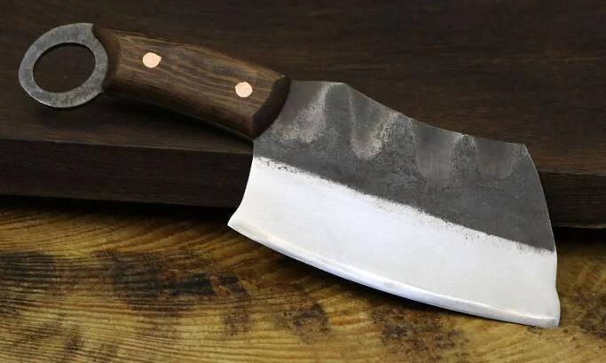 Handcrafted Chinese cleaver knife with high-carbon steel blade on wooden cutting board