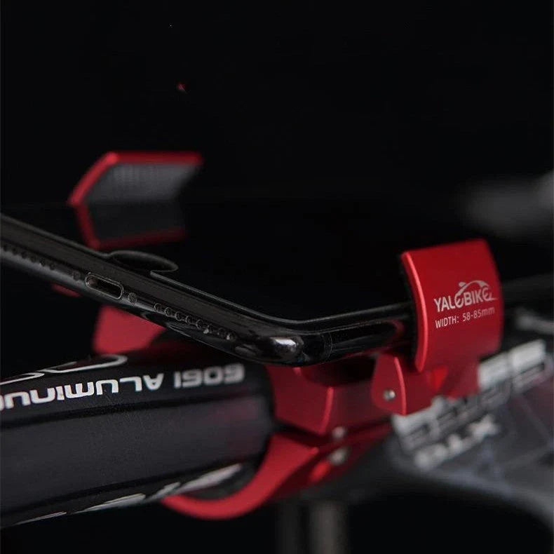 Robust folding bicycle phone holder made of aluminium alloy with shock-absorbing silicone pads for secure and hands-free cycling in the UK