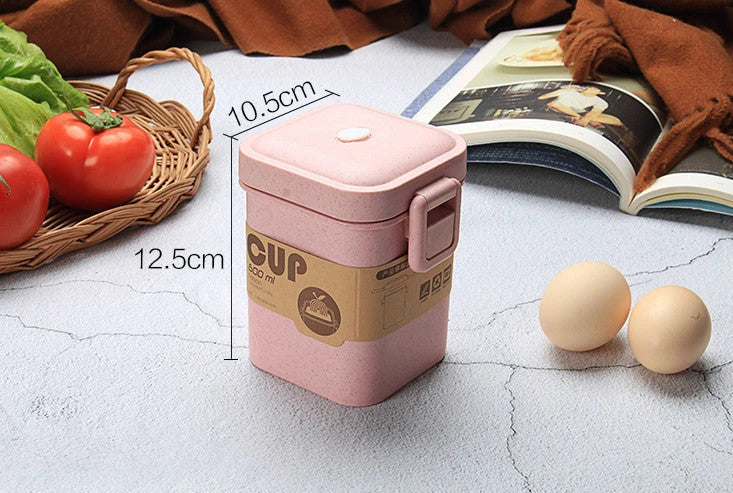 A stylish microwave-safe lunch box with a removable soup mug in various colours, including pink, green, and apricot