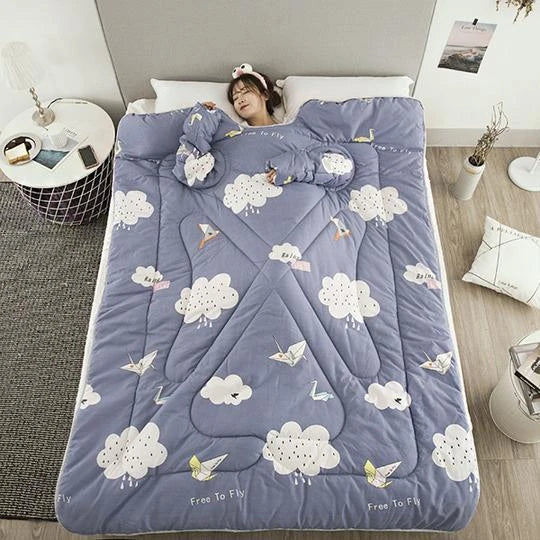 Cozy quilted lounger with sleeves in various colors and sizes, perfect for year-round indoor comfort and relaxation.
