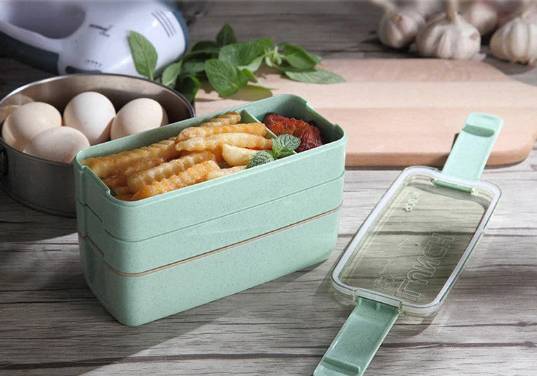 A stylish microwave-safe lunch box with a removable soup mug in various colours, including pink, green, and apricot