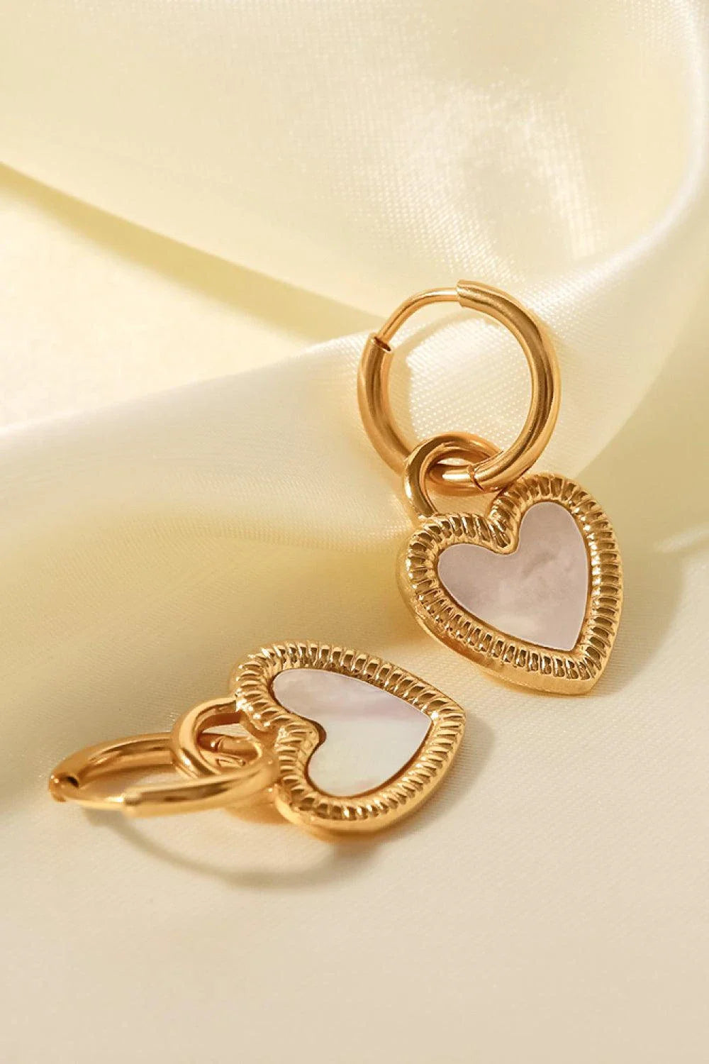 Inlaid shell heart drop earrings in gold, featuring a sophisticated and versatile design for any occasion.