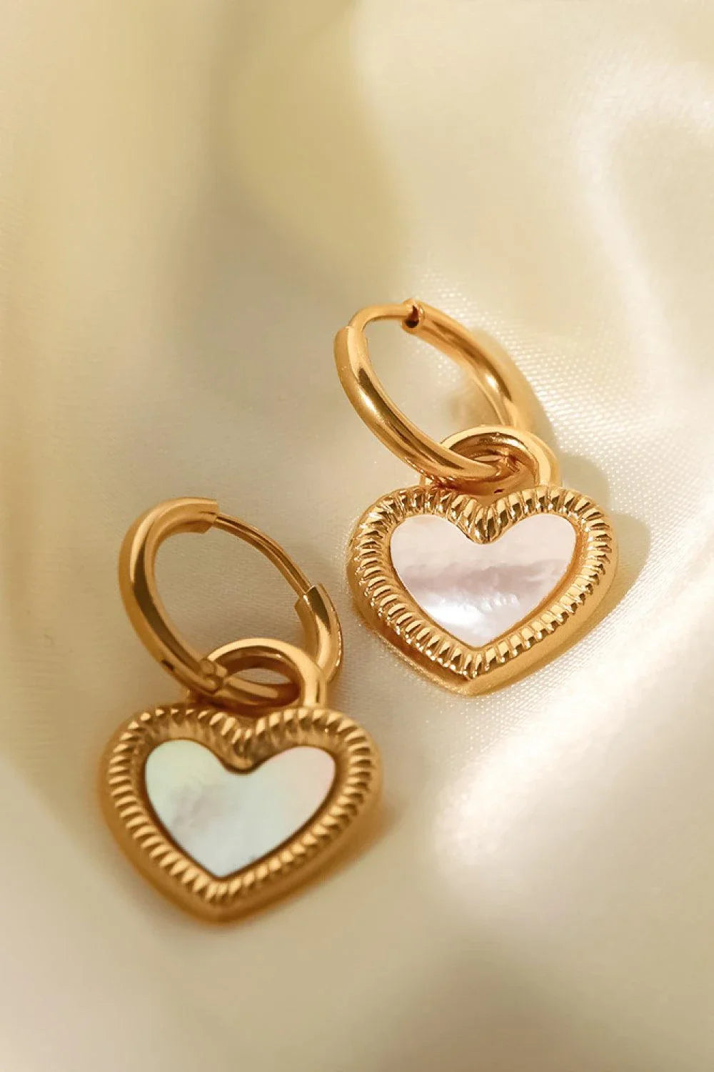 Inlaid shell heart drop earrings in gold, featuring a sophisticated and versatile design for any occasion.