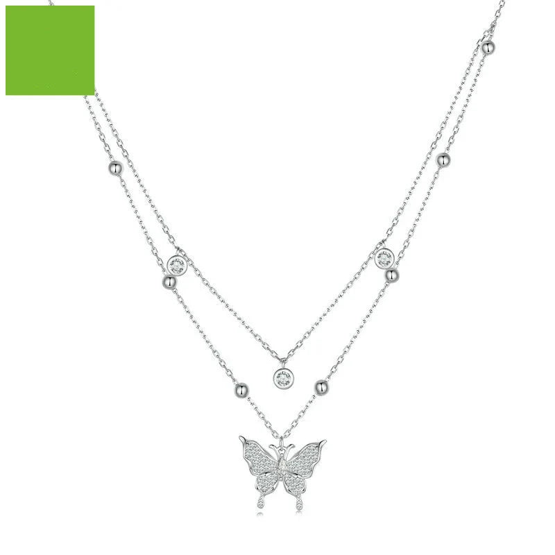 A stunning silver double-layer necklace with a captivating butterfly design and delicate fringed detailing