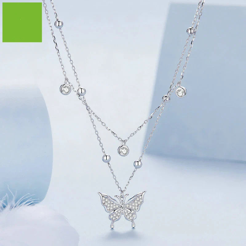A stunning silver double-layer necklace with a captivating butterfly design and delicate fringed detailing
