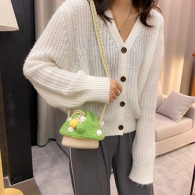 A hand-knitted wool handbag in a classic bucket shape and mini size, featuring premium cotton and linen materials