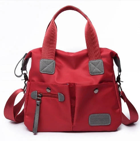 Versatile ladies shoulder bag with multiple carry options, numerous pockets, and durable Oxford fabric construction