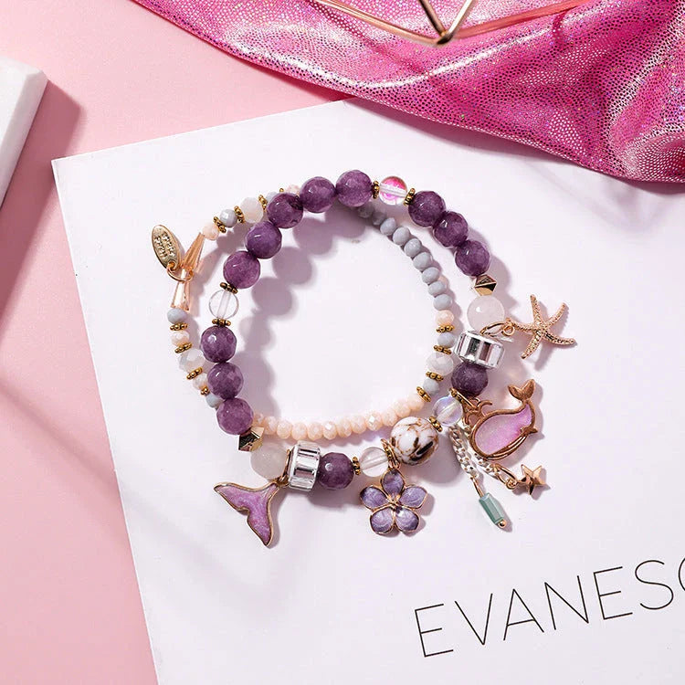 Elegant whale tail bracelet with floral charm in a variety of vibrant colours