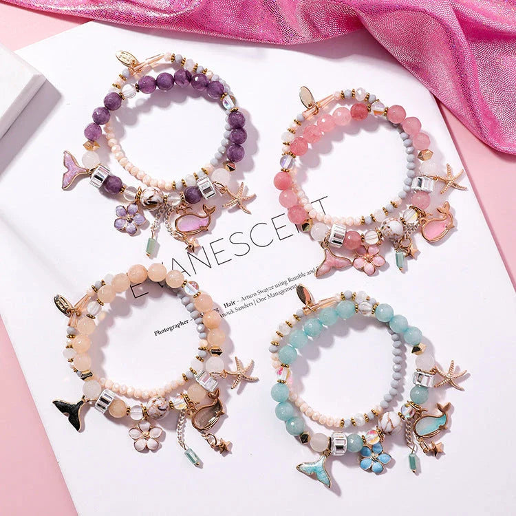 Elegant whale tail bracelet with floral charm in a variety of vibrant colours