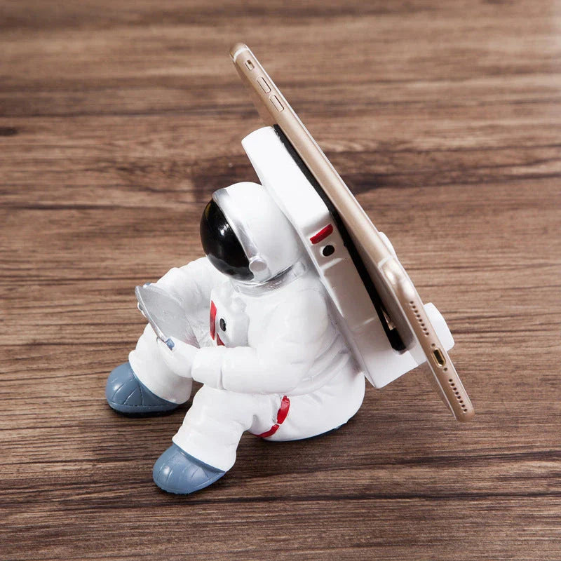 Charming astronaut-themed mobile phone stand made of high-quality resin, designed to securely hold your phone on your desk or workspace