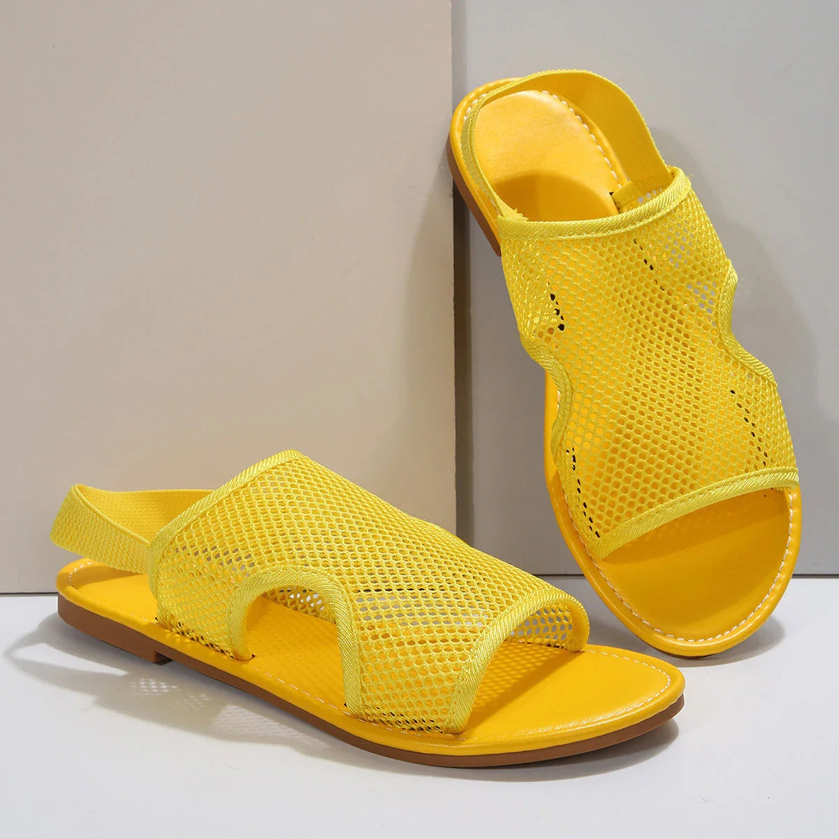 Breathable mesh sandals in various colors, featuring a lightweight design for summer comfort and style