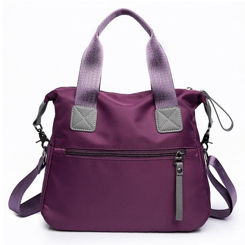 Versatile ladies shoulder bag with multiple carry options, numerous pockets, and durable Oxford fabric construction