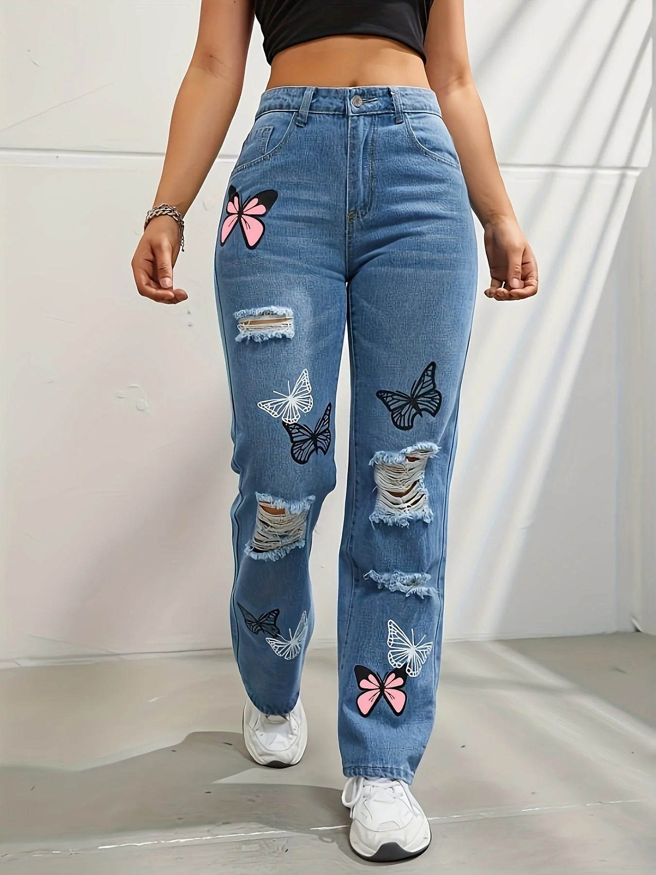 High-waisted straight leg jeans with trendy butterfly print, distressed detailing, and button closure for a stylish, flattering look.