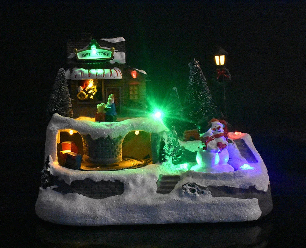 Glowing Christmas village decoration with rotating Snowman, Santa, and children, surrounded by colorful lights and playing festive music