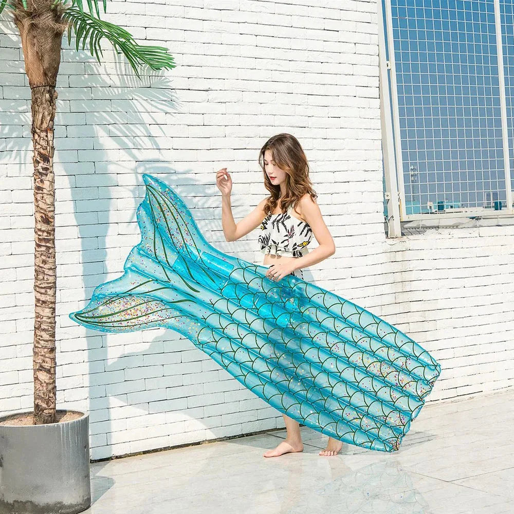 Mermaid-inspired inflatable pool lounger in vibrant blue and pink colours, offering a comfortable and stylish water relaxation experience.
