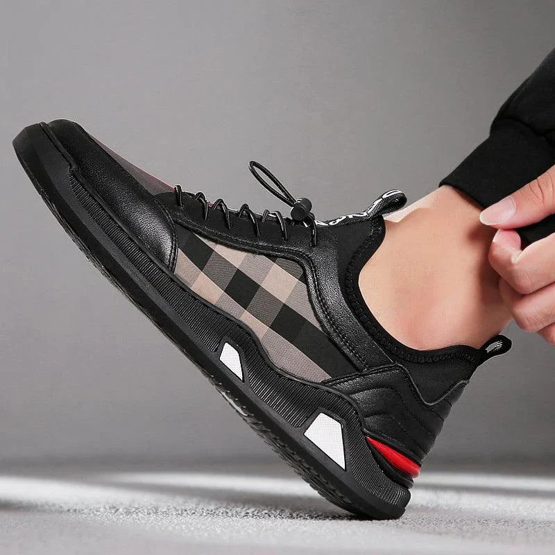 A pair of men's casual leather shoes with a sleek, lace-up design and a stylish check pattern.